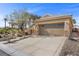 Exterior view of home with rock landscaping, desert plants, and a wide driveway at 6022 Quintillion Ave, Las Vegas, NV 89122