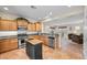 Traditional kitchen with wood cabinets, granite countertops, stainless steel appliances, and a tile floor at 6022 Quintillion Ave, Las Vegas, NV 89122