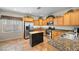 Bright kitchen featuring wood cabinets, stainless steel appliances, an island, and tile flooring at 6022 Quintillion Ave, Las Vegas, NV 89122