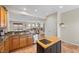 Open concept kitchen with wood cabinets, granite countertops, stainless appliances, and island overlooking the living area at 6022 Quintillion Ave, Las Vegas, NV 89122