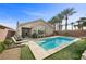 Beautiful backyard pool with artificial turf, palm trees, and lounge chairs provides a peaceful outdoor retreat at 6022 Quintillion Ave, Las Vegas, NV 89122