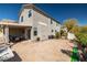 Large backyard features a covered patio area, tiled flooring, and a well-maintained lawn at 6653 Ashley House Ct, Las Vegas, NV 89139