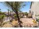 Landscaped backyard features hardscape walkway, trees, and access to the side yard at 6653 Ashley House Ct, Las Vegas, NV 89139
