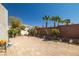 Well-kept backyard with palm trees, brick wall, and plenty of space for entertainment at 6653 Ashley House Ct, Las Vegas, NV 89139