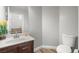 Clean bathroom with a wood-grain vanity, a modern sink, a toilet, and tile flooring at 6653 Ashley House Ct, Las Vegas, NV 89139