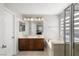 Bright bathroom with double vanity, soaking tub, and enclosed glass shower at 6653 Ashley House Ct, Las Vegas, NV 89139
