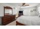 Spacious bedroom featuring neutral walls, carpet, wood furnishings, and large window with blinds at 6653 Ashley House Ct, Las Vegas, NV 89139