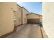 Exterior side view of the home with a garage and a well-maintained driveway at 6653 Ashley House Ct, Las Vegas, NV 89139