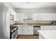 Well-lit kitchen featuring white cabinets, modern appliances, and a view from the window at 6653 Ashley House Ct, Las Vegas, NV 89139