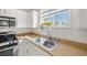 Kitchen features stainless steel sink and faucet with a view of the beautiful outdoors at 6653 Ashley House Ct, Las Vegas, NV 89139