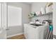 Clean and organized laundry room with modern appliances and shelving at 6653 Ashley House Ct, Las Vegas, NV 89139