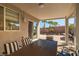 Relaxing covered patio with a dining table, tiled flooring, and easy access through sliding glass doors at 6653 Ashley House Ct, Las Vegas, NV 89139