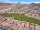 An elevated view of a Primary-planned community featuring homes and open recreational space, with scenic views at 69 Via Di Mello, Henderson, NV 89011