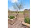 Backyard gate entry to the golf course with beautiful desert landscaping in a well-maintained outdoor space at 69 Via Di Mello, Henderson, NV 89011