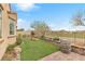 Backyard showing artificial grass, rock features, and a wall bordering a golf course at 69 Via Di Mello, Henderson, NV 89011