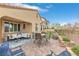 A spacious outdoor patio with a comfortable seating arrangement and a view of lush green landscaping at 69 Via Di Mello, Henderson, NV 89011