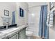 Well-lit bathroom with a vanity, marble countertop, and a shower-tub combination with a curtain at 69 Via Di Mello, Henderson, NV 89011