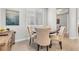 Charming breakfast nook with a round table, four upholstered chairs, and bright natural light from the window at 69 Via Di Mello, Henderson, NV 89011