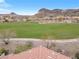 View of community green space, showcasing the neighborhood's open landscape and mountain backdrop at 69 Via Di Mello, Henderson, NV 89011