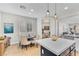 Open concept dining area with modern chandelier, neutral paint, and plenty of natural light at 69 Via Di Mello, Henderson, NV 89011