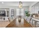 Bright dining room featuring a wooden table, stylish chairs, and contemporary lighting fixture, perfect for Gathering gatherings at 69 Via Di Mello, Henderson, NV 89011