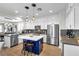 Bright kitchen boasts white cabinets, a blue island, and stainless steel appliances at 69 Via Di Mello, Henderson, NV 89011