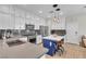 Modern kitchen featuring stainless steel appliances, white cabinetry, a center island with seating, and stone countertops at 69 Via Di Mello, Henderson, NV 89011