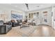 Cozy living room with hardwood floors, a ceiling fan, and plenty of natural light at 69 Via Di Mello, Henderson, NV 89011