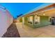 A delightful covered patio with string lights creates a cozy outdoor space, enhanced by a low maintenance landscape design at 7341 Girard Dr, Las Vegas, NV 89147