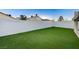 The large backyard features artificial turf and a tall privacy wall for outdoor enjoyment at 7341 Girard Dr, Las Vegas, NV 89147