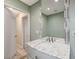 Bathroom with tile surround shower, white cabinet, marble countertop, and large mirror at 7341 Girard Dr, Las Vegas, NV 89147