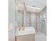 Bathroom with tile surround shower behind glass, white cabinet, and marble countertops at 7341 Girard Dr, Las Vegas, NV 89147