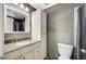 Bathroom with granite counters, stylish vanity, toilet, and a shower behind a dark curtain at 7341 Girard Dr, Las Vegas, NV 89147