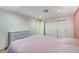 Bedroom with pink walls, carpeted floors, base molding, and a built-in wardrobe at 7341 Girard Dr, Las Vegas, NV 89147