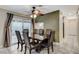A formal dining room features tile floors, a ceiling fan, and slider access to patio at 7341 Girard Dr, Las Vegas, NV 89147
