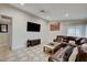Inviting living room featuring a large sectional, TV, and stylish decor on checkered tile at 7341 Girard Dr, Las Vegas, NV 89147