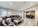 Open-concept space with a sectional sofa, dining area, and checkered tile floor at 7341 Girard Dr, Las Vegas, NV 89147