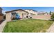 Spacious backyard featuring a play structure, patio with seating, and well-maintained lawn at 7712 Bandon Cliffs St, North Las Vegas, NV 89084