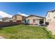 Backyard with green lawn, patio, play equipment, and privacy fence at 7712 Bandon Cliffs St, North Las Vegas, NV 89084