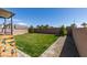 Backyard with manicured lawn, brick patio, and gravel landscaping at 7712 Bandon Cliffs St, North Las Vegas, NV 89084