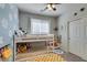 ' bedroom with a bunk bed, daisy wallpaper, and pops of bright yellow in the decor at 7712 Bandon Cliffs St, North Las Vegas, NV 89084