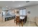 Open-concept kitchen and dining area with an island that provides seating and granite countertops at 7712 Bandon Cliffs St, North Las Vegas, NV 89084