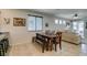 Well-lit dining area featuring a table with bench seating and seamless flow into the living room at 7712 Bandon Cliffs St, North Las Vegas, NV 89084