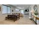 Bright dining area with view into the living room, with tile flooring, a bench, and a four-chair table at 7712 Bandon Cliffs St, North Las Vegas, NV 89084