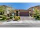 Charming single Gathering home featuring a well-manicured front yard with desert landscaping and a two-car garage at 7712 Bandon Cliffs St, North Las Vegas, NV 89084
