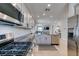 Spacious kitchen equipped with stainless steel appliances, granite countertops, and an island sink overlooking the living area at 7712 Bandon Cliffs St, North Las Vegas, NV 89084