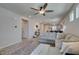Open living space and dining area with neutral sectional sofa, tile flooring, and bright lighting at 7712 Bandon Cliffs St, North Las Vegas, NV 89084