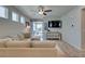 Comfortable living room featuring a large sectional sofa, modern ceiling fan, and access to the outdoor patio at 7712 Bandon Cliffs St, North Las Vegas, NV 89084