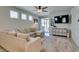 Inviting living room with a comfortable sectional, neutral decor, and sliding glass doors to the outdoor space at 7712 Bandon Cliffs St, North Las Vegas, NV 89084