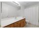 Full bathroom with modern sink and faucet, white countertop and cabinets and shower/tub combo at 7828 Morning Flower Ln, Las Vegas, NV 89129
